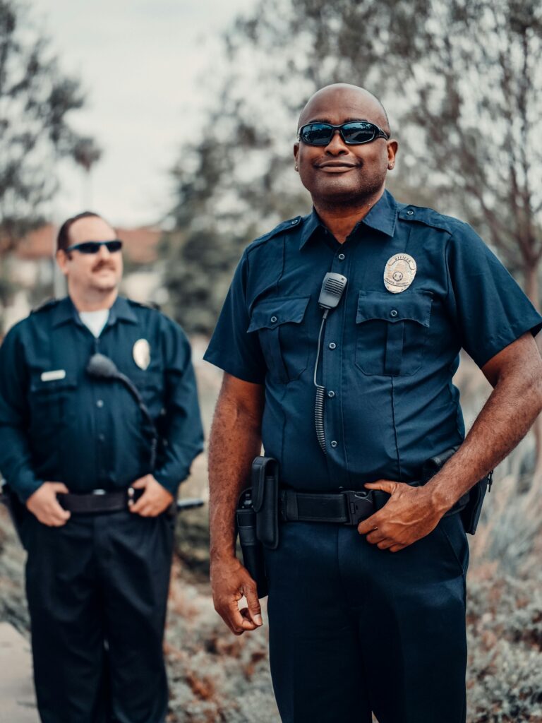 Two interracial security standing and keeping an eye to observe surrounding. 